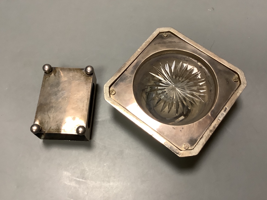 A George V silver mounted cut glass inkwell, goldsmiths and silversmiths Co Ltd, London 1914, 11.4cm and a silver matchbox sleeve.